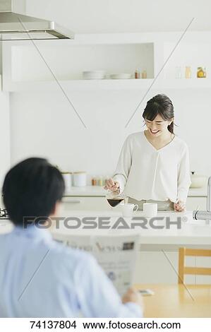 Picture - Japanese couple in the kitchen. Fotosearch