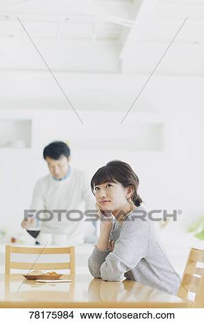 Picture - Japanese couple in the kitchen. Fotosearch