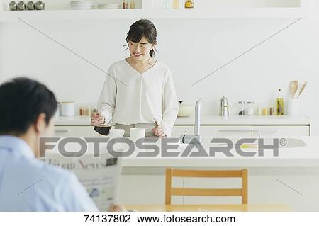 Stock Image - Japanese couple in the kitchen. Fotosearch