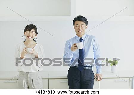 Stock Image - Japanese couple in the kitchen. Fotosearch