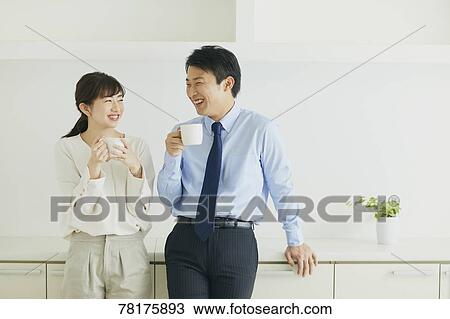 Stock Image - Japanese couple in the kitchen. Fotosearch