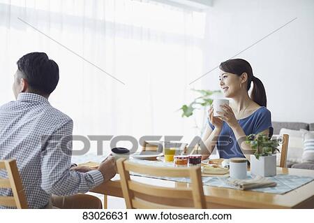 Stock Image - Japanese couple in the kitchen. Fotosearch