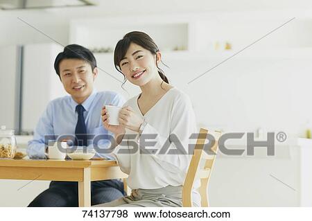Stock Photo - Japanese couple in the kitchen. Fotosearch