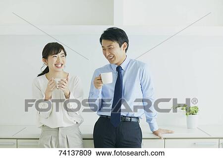 Stock Photo - Japanese couple in the kitchen. Fotosearch