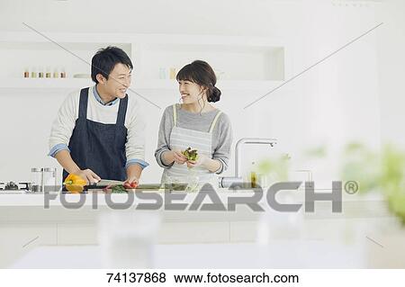 Stock Photo - Japanese couple in the kitchen. Fotosearch
