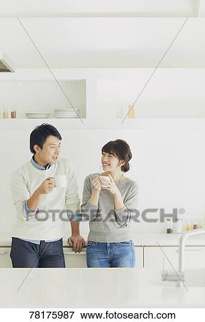 Stock Photo - Japanese couple in the kitchen. Fotosearch