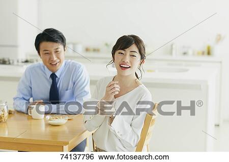 Stock Photograph - Japanese couple in the kitchen. Fotosearch