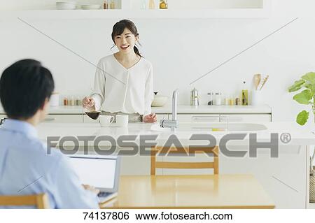 Stock Photograph - Japanese couple in the kitchen. Fotosearch