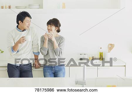 Stock Photograph - Japanese couple in the kitchen. Fotosearch