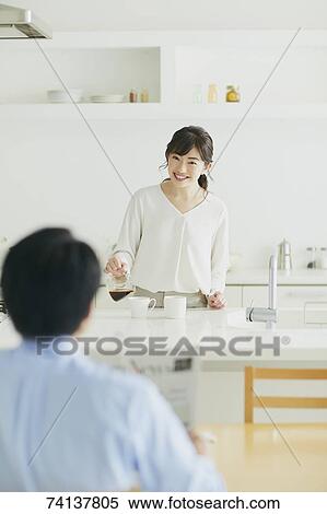 Stock Photography - Japanese couple in the kitchen. Fotosearch