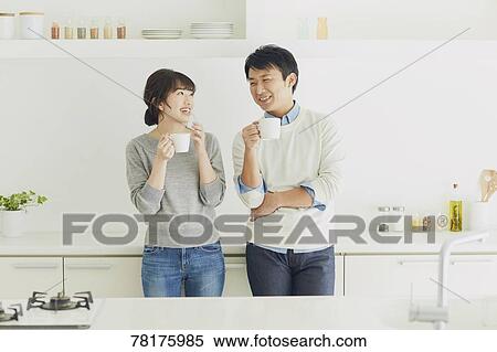 Stock Photography - Japanese couple in the kitchen. Fotosearch