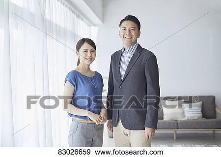 Stock Photo - Japanese couple in the living room. Fotosearch