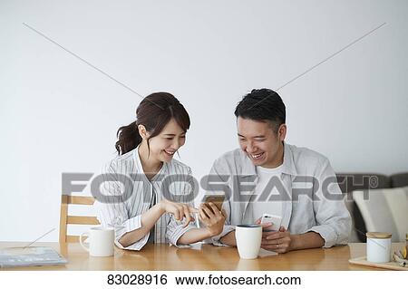 Stock Photograph - Japanese couple in the living room. Fotosearch
