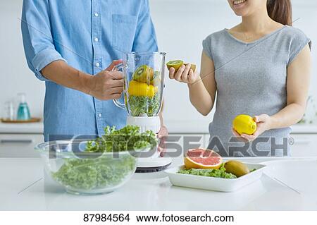 Japanese couple making smoothie in the kitchen View Large Photo Image Picture - Japanese couple making smoothie in the kitchen. Fotosearch
