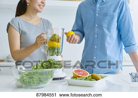 Japanese couple making smoothie in the kitchen View Large Photo Image Stock Image - Japanese couple making smoothie in the kitchen. Fotosearch