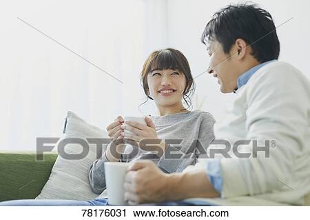 Stock Image - Japanese couple on the sofa. Fotosearch