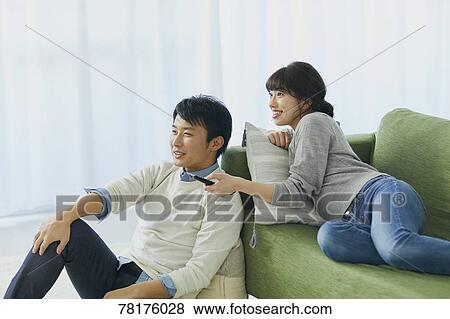 Stock Photo - Japanese couple on the sofa. Fotosearch