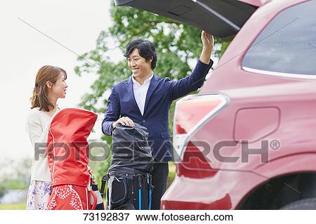 Japanese couple preparing to play golf View Large Photo Image Stock Photo - Japanese couple preparing to play golf. Fotosearch