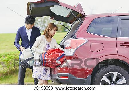 Japanese couple preparing to play golf View Large Photo Image Stock Photo - Japanese couple preparing to play golf. Fotosearch