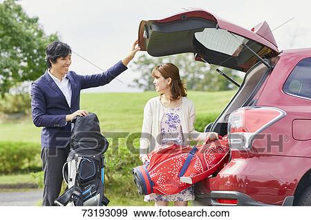 Japanese couple preparing to play golf View Large Photo Image Stock Photo - Japanese couple preparing to play golf. Fotosearch