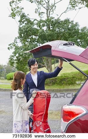 Japanese couple preparing to play golf View Large Photo Image Stock Photograph - Japanese couple preparing to play golf. Fotosearch
