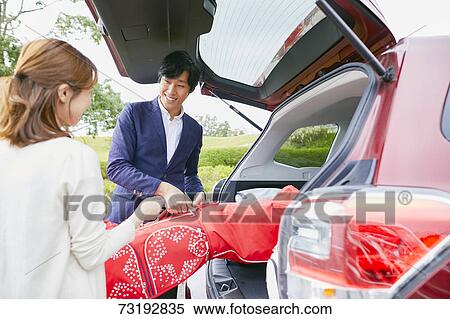 Japanese couple preparing to play golf View Large Photo Image Stock Photography - Japanese couple preparing to play golf. Fotosearch