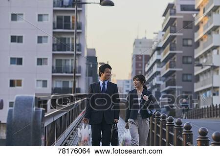 Japanese couple walking home from work View Large Photo Image Picture - Japanese couple walking home from work. Fotosearch