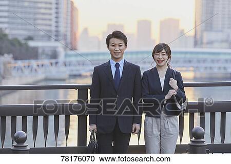 Japanese couple walking home from work View Large Photo Image Stock Image - Japanese couple walking home from work. Fotosearch