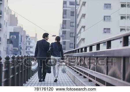 Japanese couple walking home from work View Large Photo Image Stock Image - Japanese couple walking home from work. Fotosearch