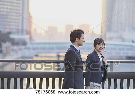 Japanese couple walking home from work View Large Photo Image Stock Photo - Japanese couple walking home from work. Fotosearch