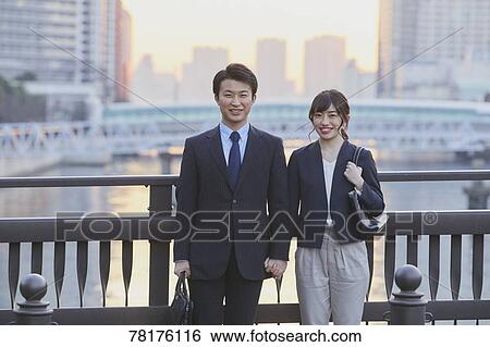 Stock Photograph - Japanese couple walking home from work. Fotosearch