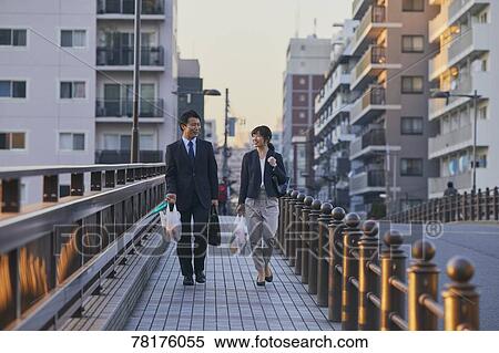 Japanese couple walking home from work View Large Photo Image Stock Photography - Japanese couple walking home from work. Fotosearch