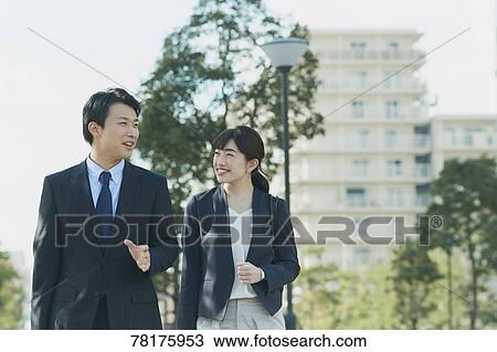 Stock Image - Japanese couple walking to work. Fotosearch