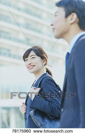 Stock Image - Japanese couple walking to work. Fotosearch