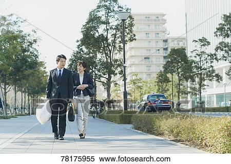 Japanese couple walking to work View Large Photo Image Stock Photography - Japanese couple walking to work. Fotosearch