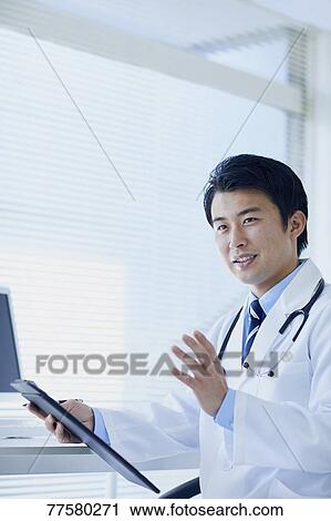 Stock Image - Japanese doctor in his studio. Fotosearch
