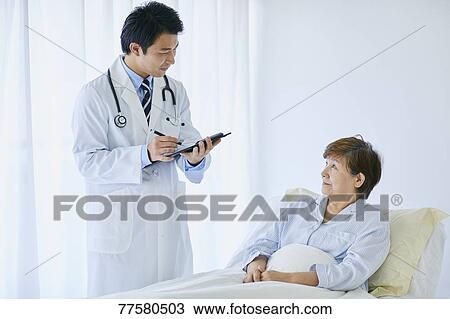 Japanese doctor with a patient in bed View Large Photo Image Stock Image - Japanese doctor with a patient in bed. Fotosearch