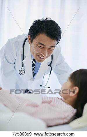 Japanese doctor with a patient in bed View Large Photo Image Stock Photo - Japanese doctor with a patient in bed. Fotosearch