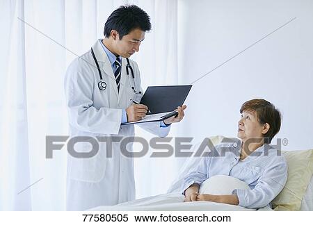 Japanese doctor with a patient in bed View Large Photo Image Stock Photography - Japanese doctor with a patient in bed. Fotosearch