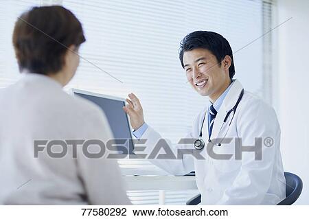 Japanese doctor with a patient in his studio View Large Photo Image Stock Image - Japanese doctor with a patient in his studio. Fotosearch