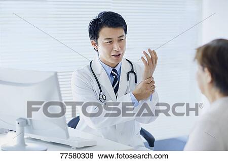 Japanese doctor with a patient in his studio View Large Photo Image Stock Photo - Japanese doctor with a patient in his studio. Fotosearch