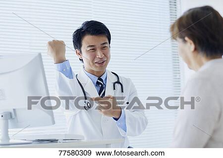 Japanese doctor with a patient in his studio View Large Photo Image Stock Photo - Japanese doctor with a patient in his studio. Fotosearch