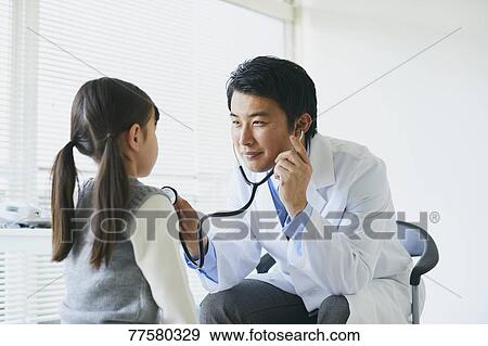 Japanese doctor with a patient in his studio View Large Photo Image Stock Photo - Japanese doctor with a patient in his studio. Fotosearch