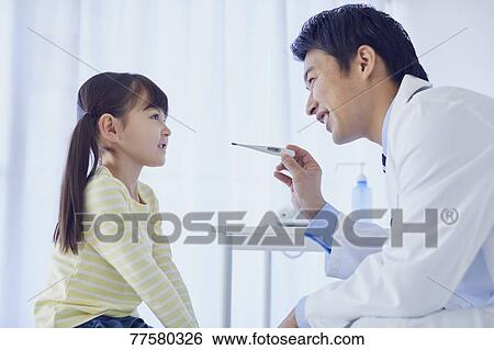 Stock Photograph - Japanese doctor with a patient in his studio. Fotosearch
