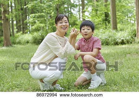 Picture - Japanese family in a city park. Fotosearch