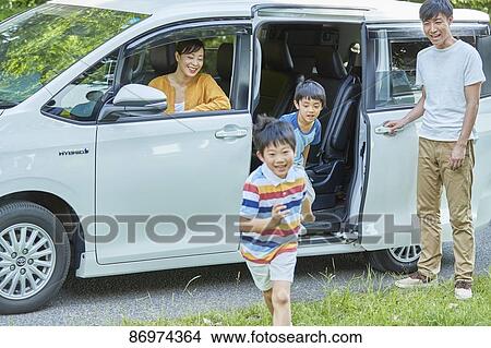 Picture - Japanese family in a city park. Fotosearch