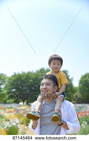 Picture - Japanese family in a city park. Fotosearch