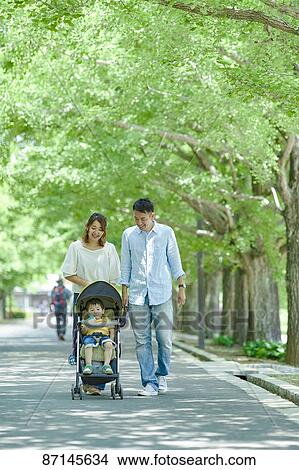 Picture - Japanese family in a city park. Fotosearch