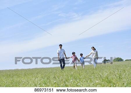 Stock Image - Japanese family in a city park. Fotosearch