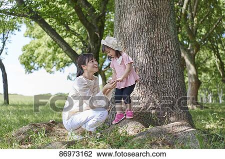 Japanese family in a city park View Large Photo Image Stock Image - Japanese family in a city park. Fotosearch